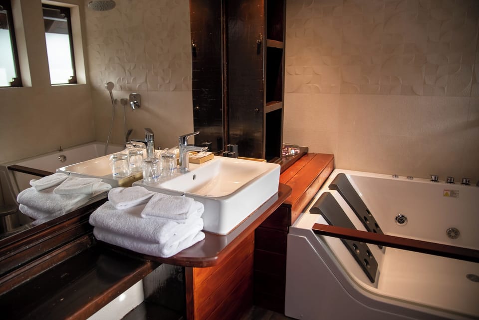 Deluxe Double Room, River View | Bathroom | Free toiletries, hair dryer, slippers, towels