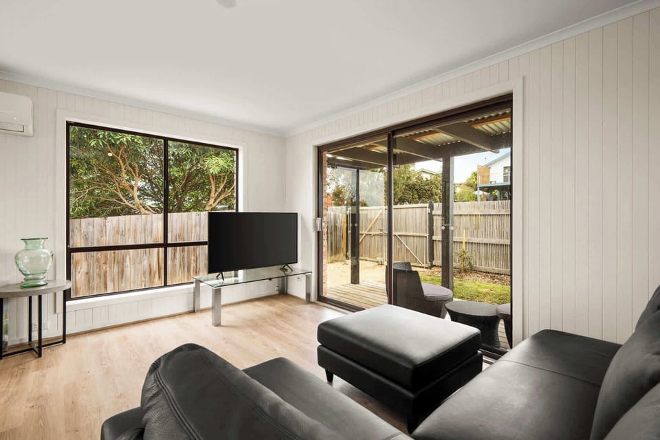 Light-filled living room with TV and ample seating