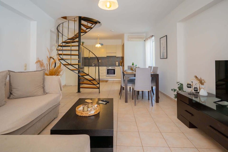 Entrance to the apartment. Living room, dining area, staricase to the bedrooms and kitchen.