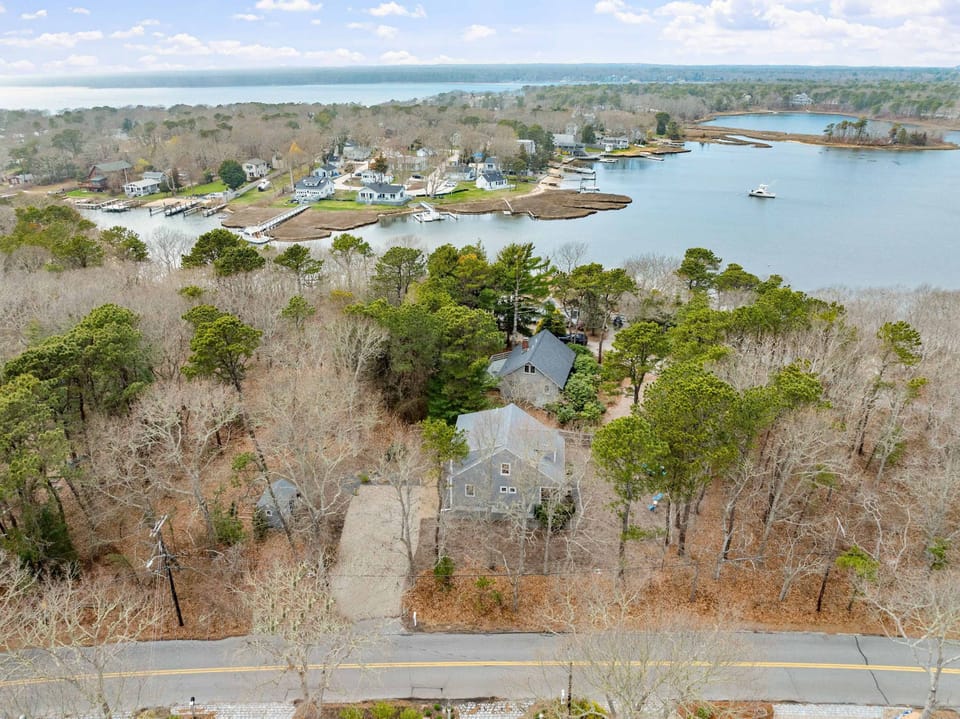 Nestled among the trees, this charming retreat offers a rare blend of privacy and coastal living—just steps from the shoreline!