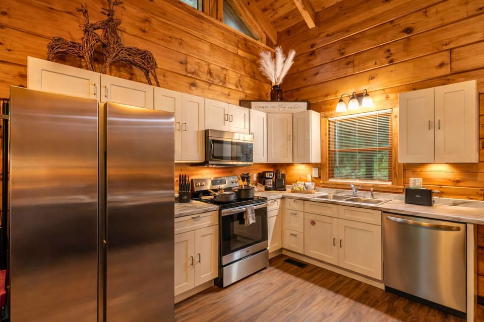 Cook with ease in a fully equipped, modern rustic kitchen featuring stainless steel appliances, both Keurig and drip coffee makers, and everything needed for gourmet meals.