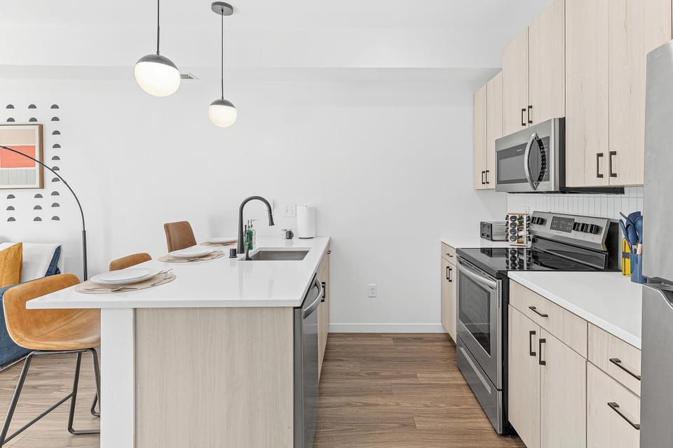Bright modern kitchen with waterfall island and stylish bar seating