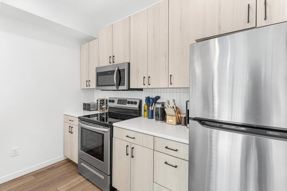 Bright modern kitchen with stainless appliances and ample storage