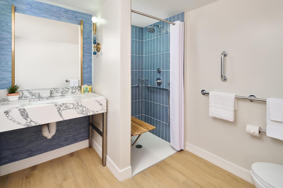Signature Room, 1 King Bed, Resort View (Accessible) | Bathroom | Rainfall showerhead, eco-friendly toiletries, hair dryer, towels