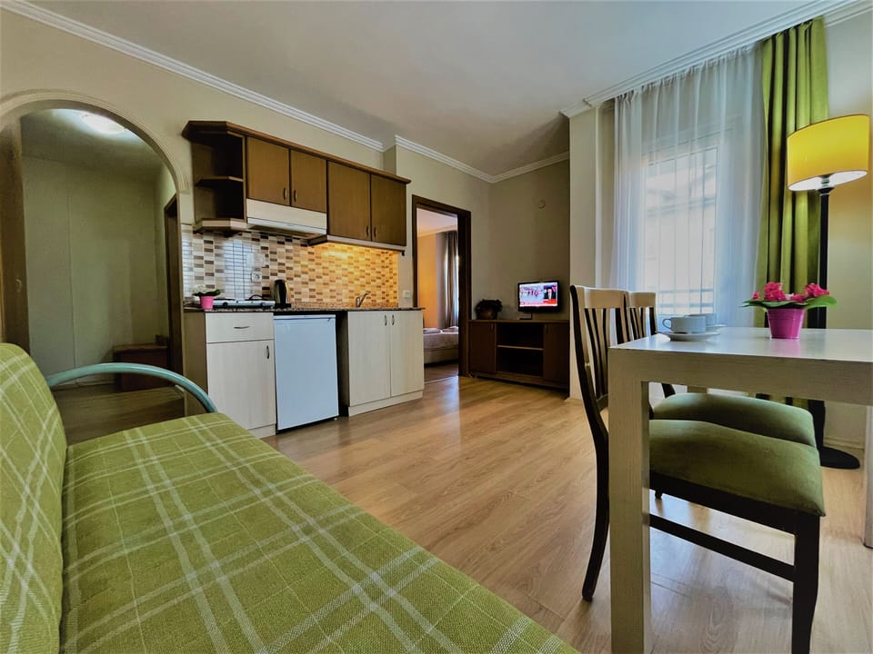 Family Apartment, 1 Bedroom, Kitchenette, Partial Sea View | Premium bedding, minibar, in-room safe, desk