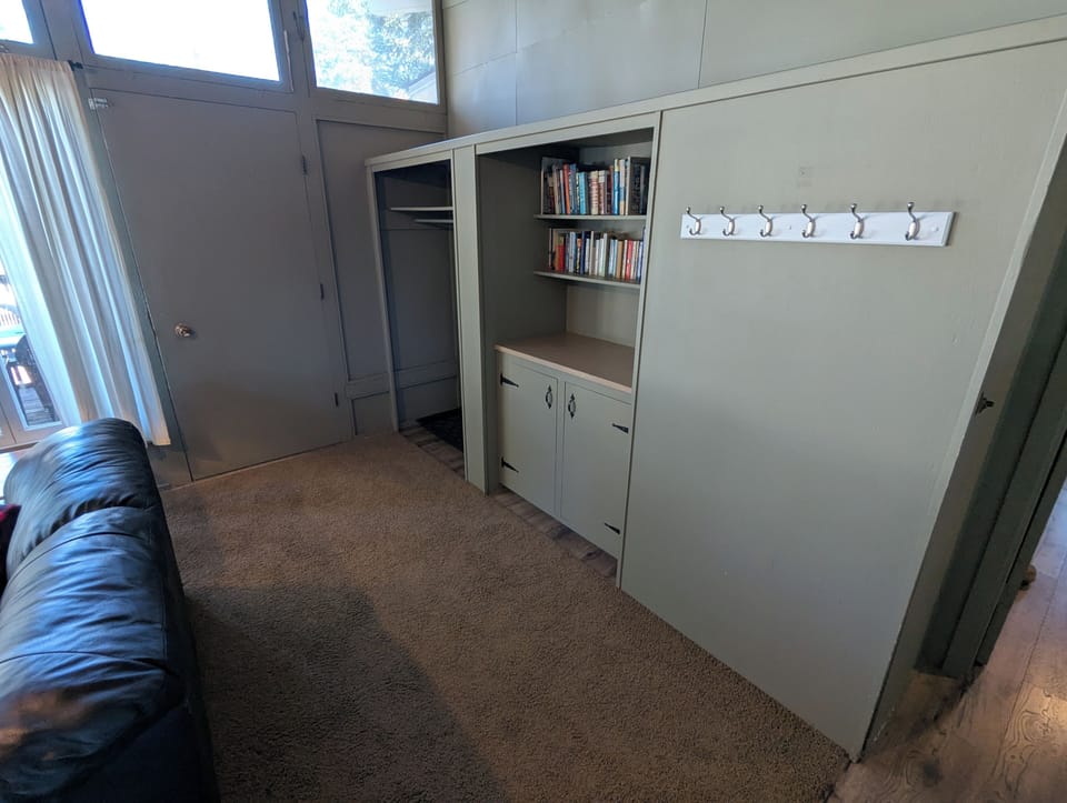 The entrance offers plenty of storage a house library and games cupboard