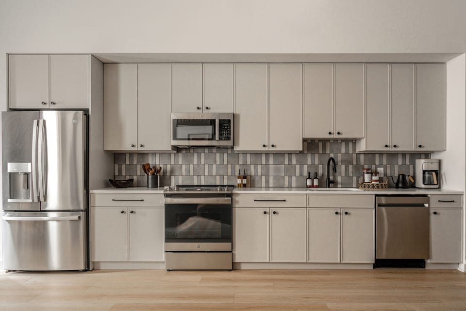 Fully equipped modern kitchen with sleek stainless steel appliances.