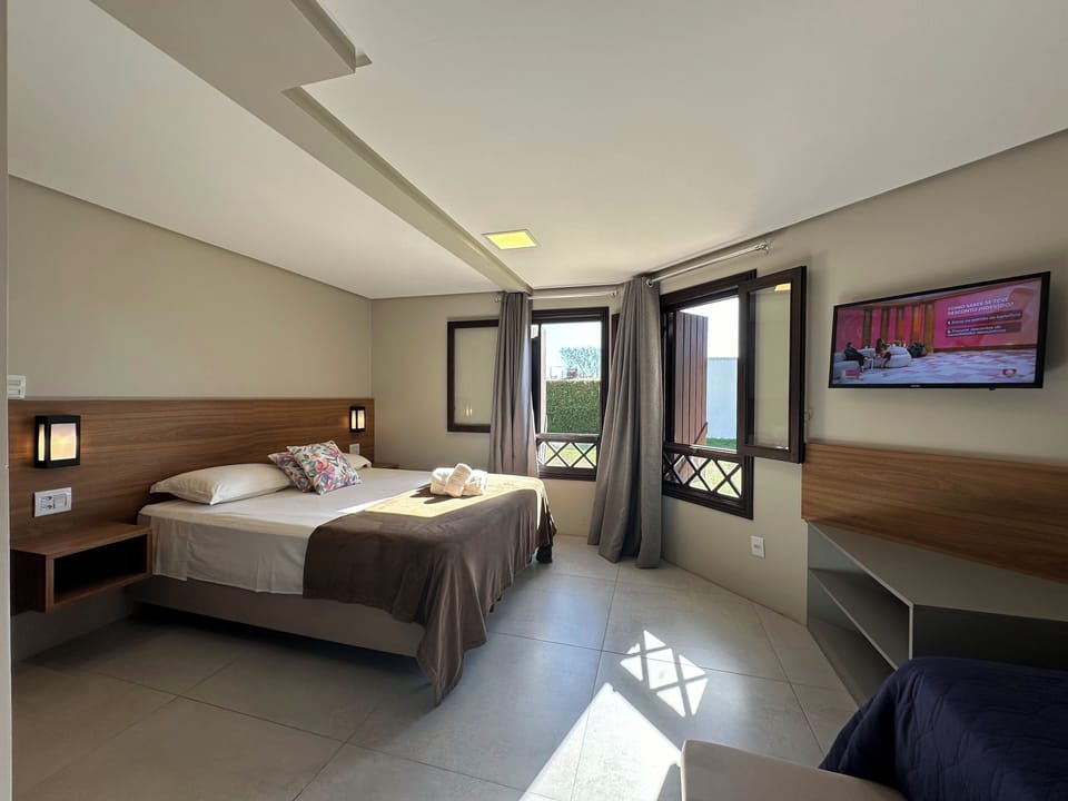 Family Triple Room, Garden View | Minibar, laptop workspace, blackout drapes, iron/ironing board