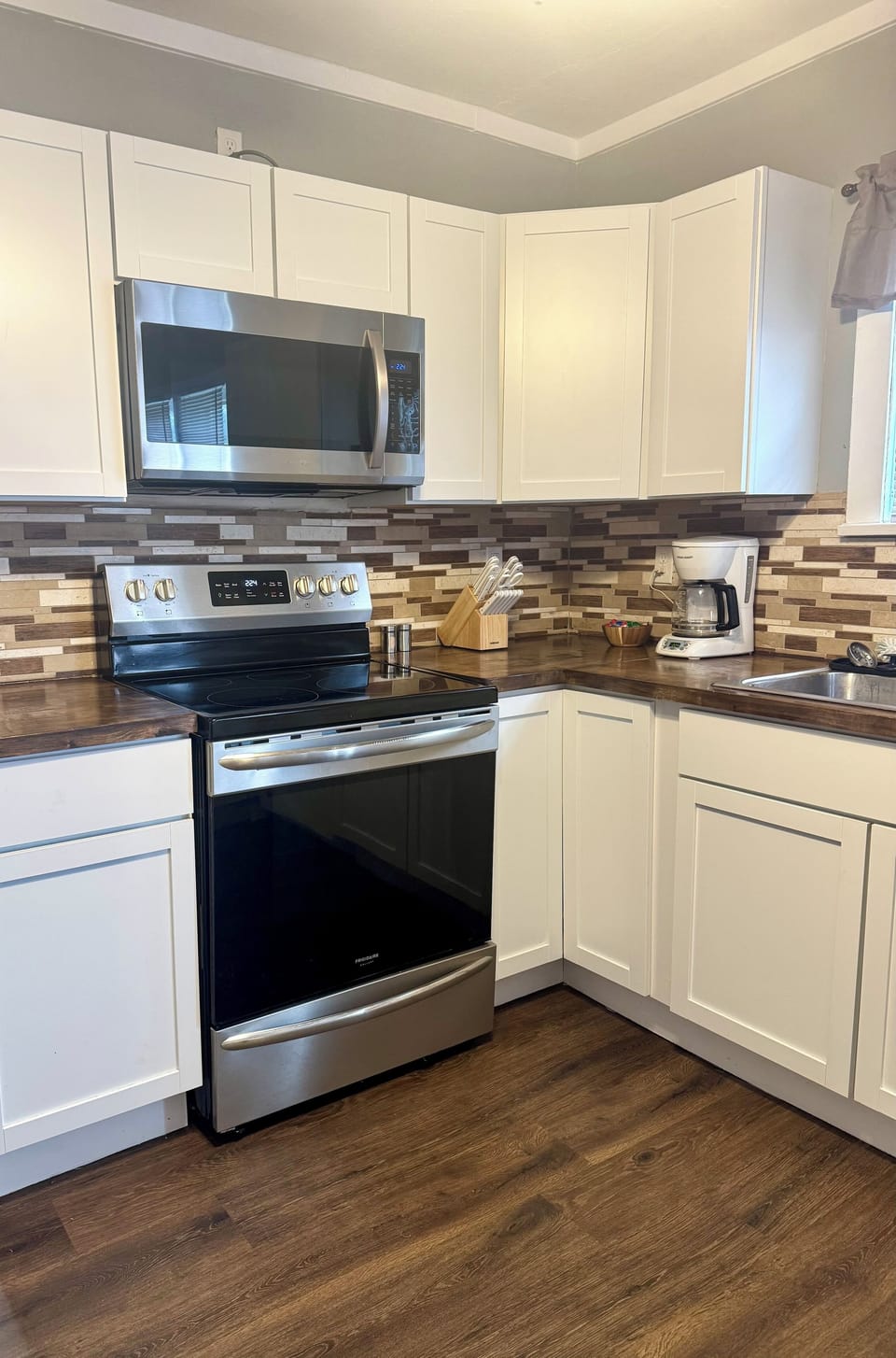 Microwave, stove, coffee pot and creamers