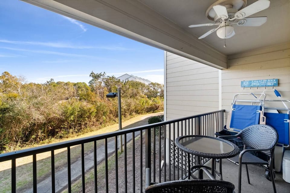 Patio with outdoor dining for two and beach essentials 