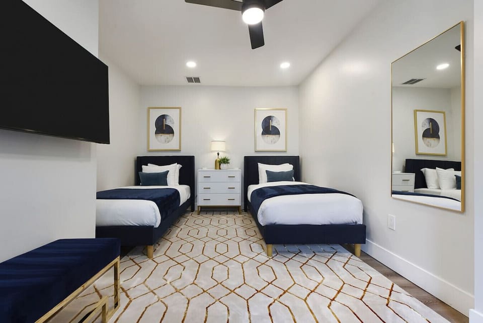 Modern twin bedroom with stylish decor and plenty of natural light, perfect for families or groups.