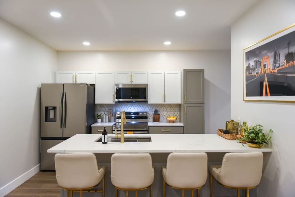 Stylish kitchen with a spacious island and modern appliances, perfect for meal preparation and gathering.