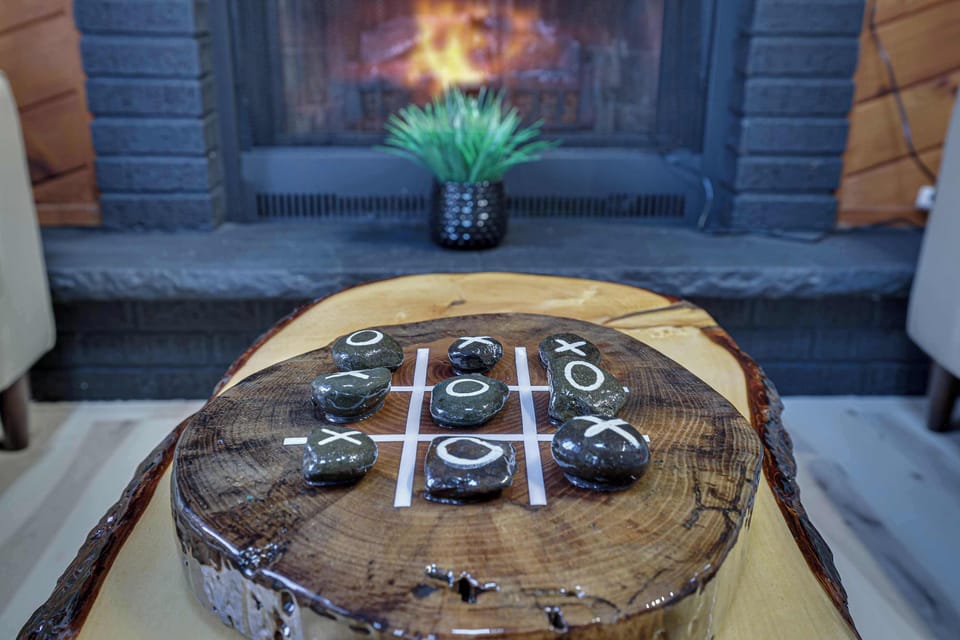 Gather around the living room’s stylish tic-tac-toe center table for some playful fun or simply enjoy a cozy moment with family and friends.