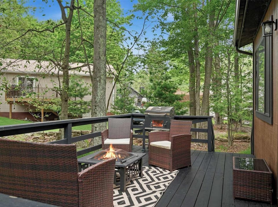Unwind on the deck patio, where the firepit center table creates the perfect gathering spot. Enjoy cozy evenings with warmth, conversation, and beautiful outdoor vibes.