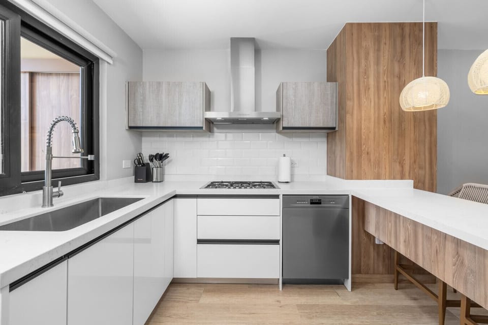 Here’s a closer look at this chic kitchen! The sleek design and cozy lighting make it the perfect spot to cook and hang out.