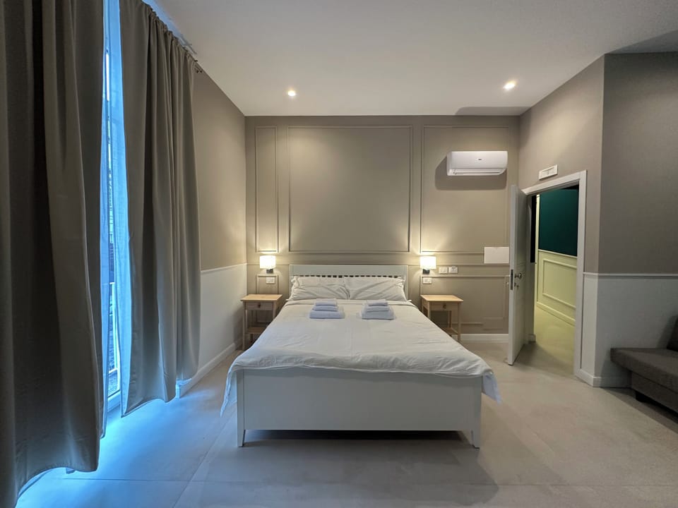 Deluxe Quadruple Room, Balcony, City View | Blackout drapes, soundproofing, iron/ironing board, free WiFi