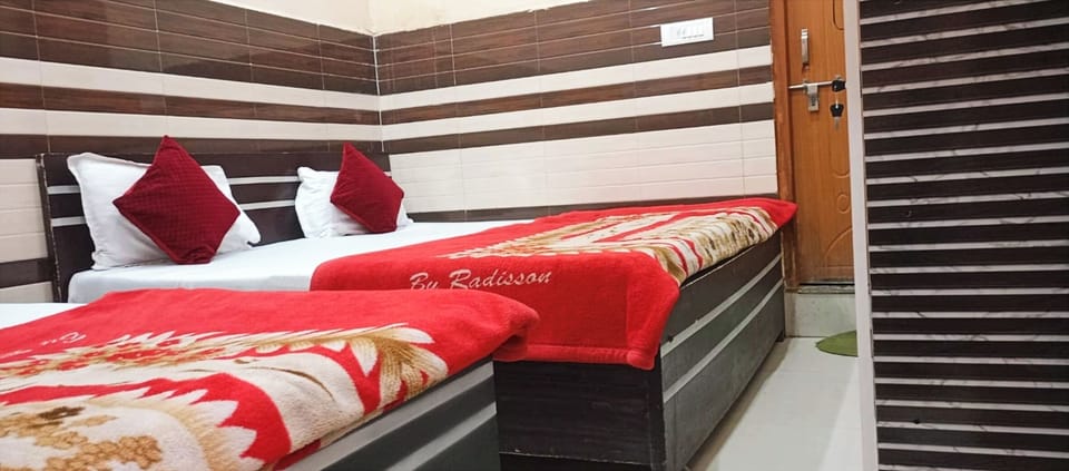 Deluxe Quadruple Room, City View | Desk, laptop workspace, bed sheets