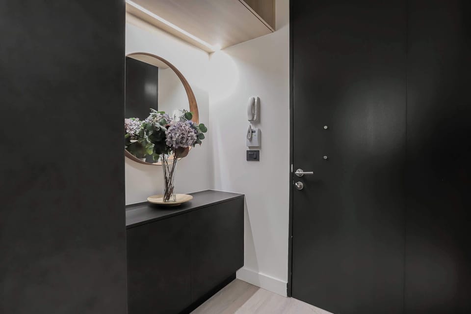 Step into elegance with a chic entryway featuring a stylish mirror and floral accents, setting the tone for a memorable stay.