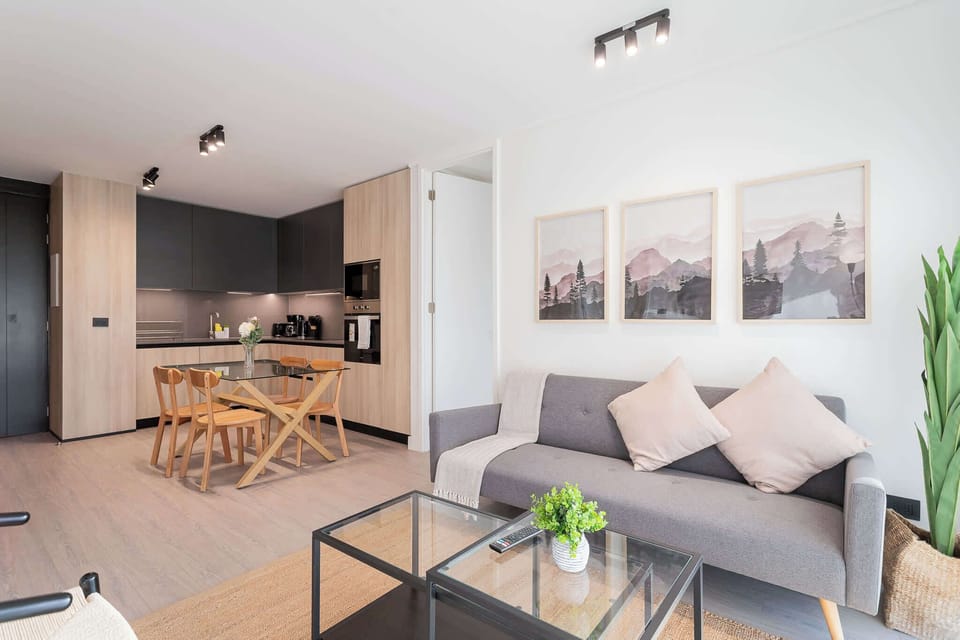 Experience modern comfort in this stylish living area, featuring a sleek kitchen and cozy seating—perfect for relaxation after a day of adventure!