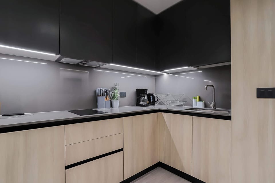 Experience culinary delight in this sleek, modern kitchen with top-notch amenities and stylish design.