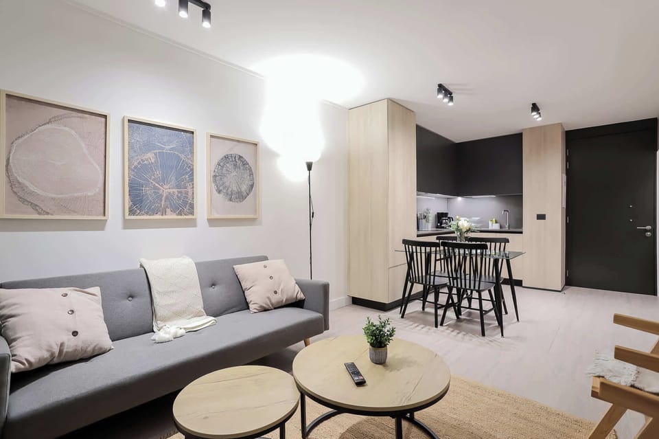 Modern and cozy living space with stylish decor and a welcoming dining area, perfect for relaxing and entertaining.