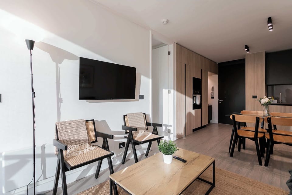 Experience modern comfort in this stylish living space, perfect for relaxation and dining in a chic, minimalist setting.