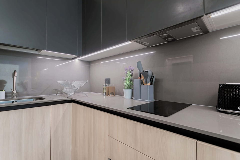 Experience culinary delight in this sleek, modern kitchen with top-notch amenities and stylish design.