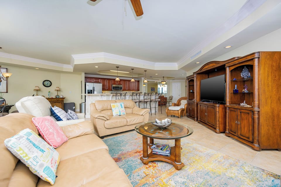 Unwind in the inviting living space, featuring a queen sofa sleeper, with coastal accents for serene moments together