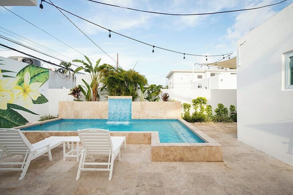 Pool Area has lounge chairs, outside shower and a half bathroom.