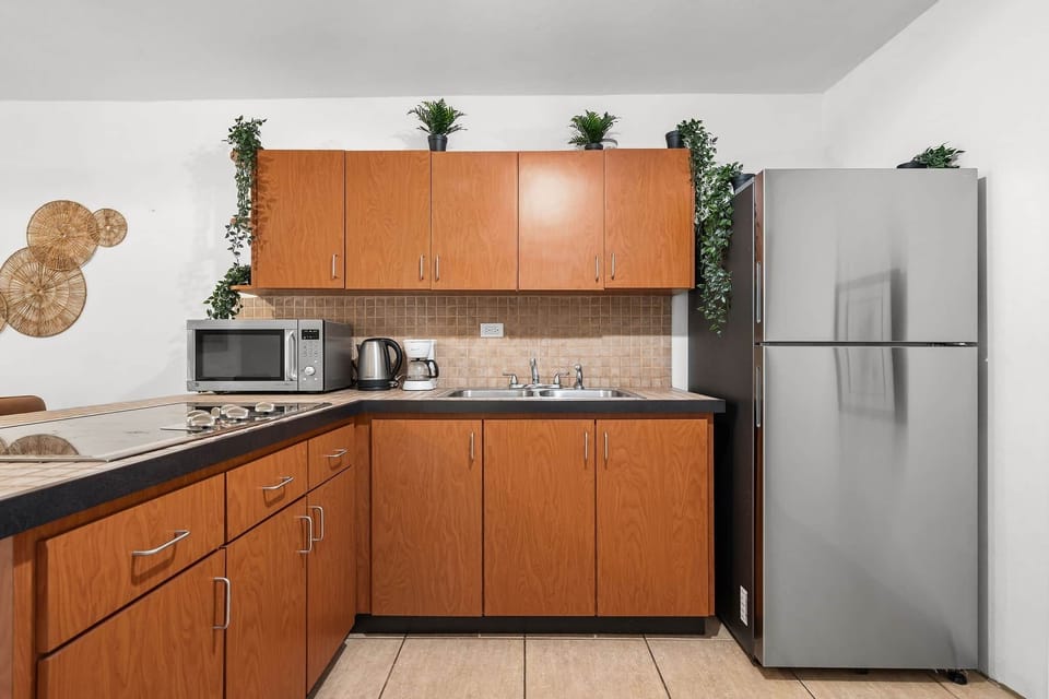 Bright kitchen with full-size appliances and warm wood cabinetry