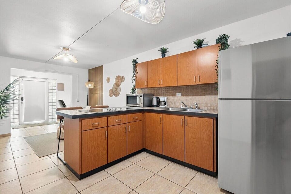 Bright kitchen with full-size appliances and warm wood cabinetry