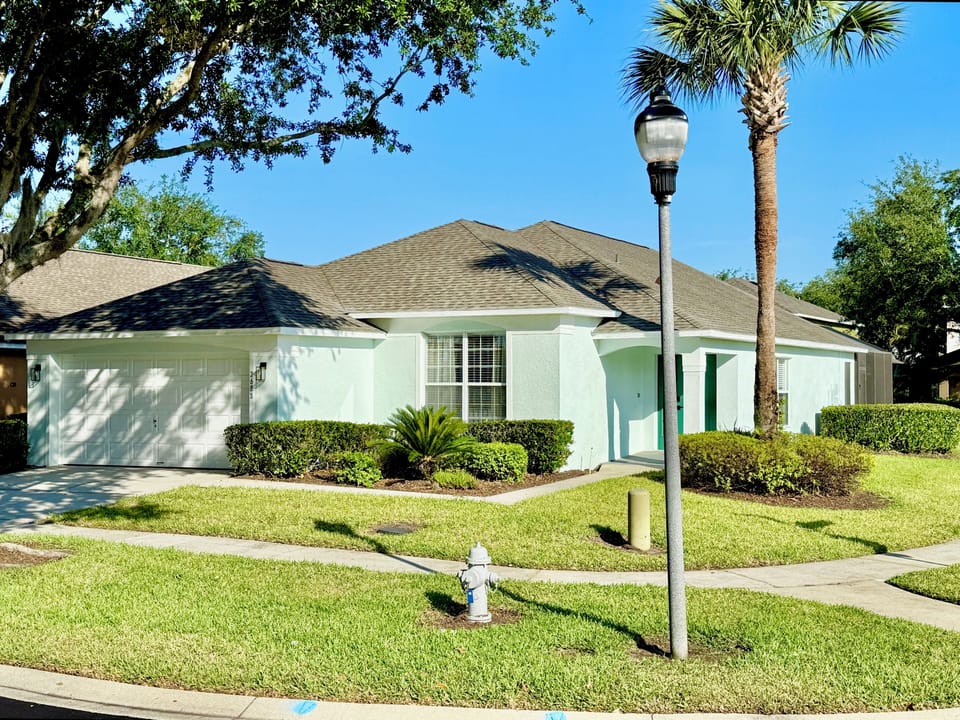 Front view of this sun-drenched villa and garage
