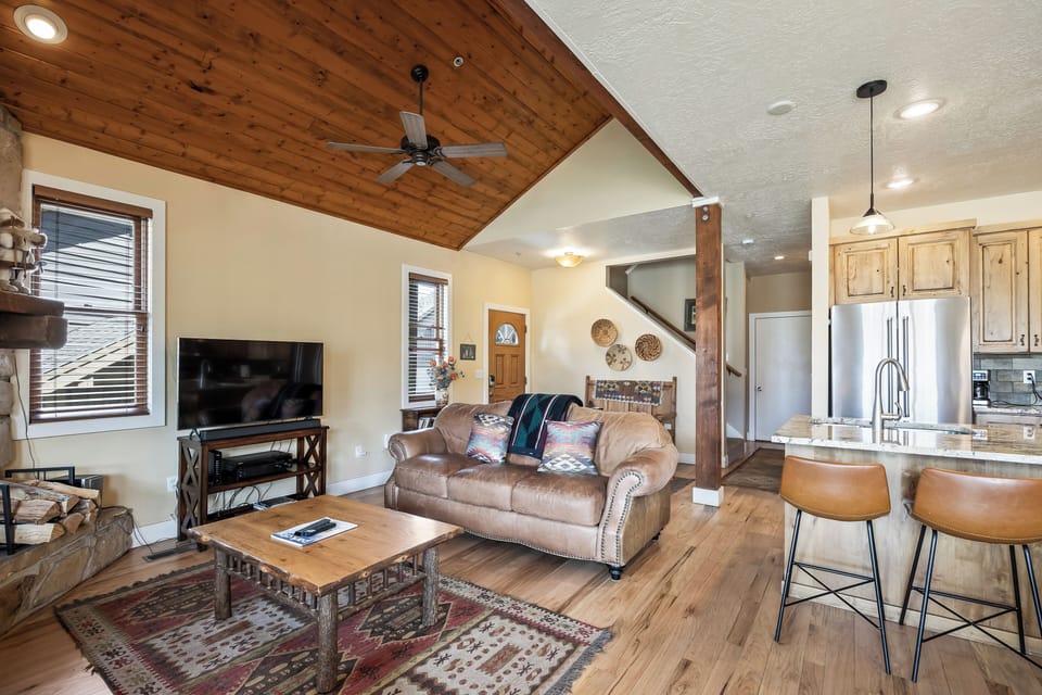 - Kick back with your favorite movie or game in this rustic yet comfy space
- Cozy up on the leather loveseat after a day of skiing or hiking nearby trails
- Stylish open concept design flows seamlessly from kitchen to living room