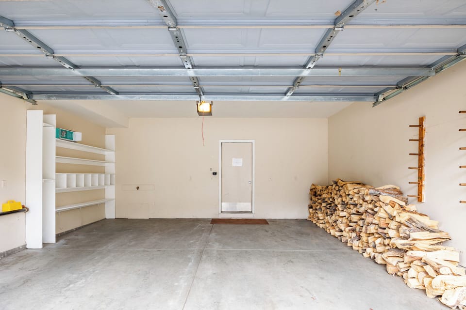 - Park with ease or stash your gear in this wide, clean, and organized garage
- Stocked firewood wall keeps the cozy vibes going all season long
- Built in shelves make it simple to store boots, skis, and outdoor essentials
