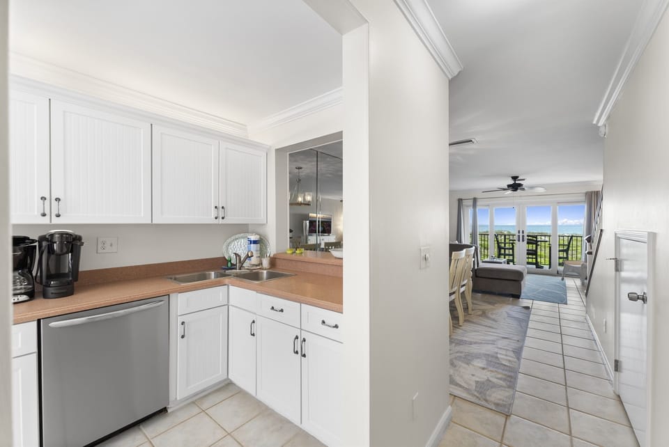 Prepare meals in a bright kitchen with captivating ocean views, creating the perfect coastal cooking experience.