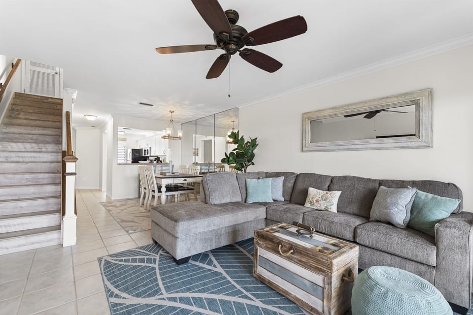 Expansive living area with vaulted ceilings, ample seating, and beautiful natural light throughout.