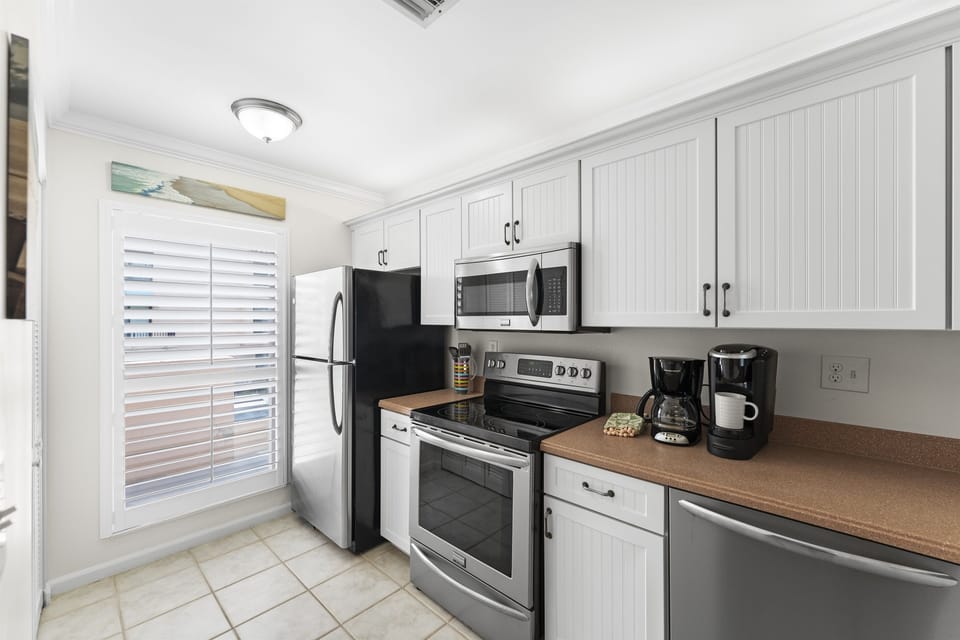 Modern kitchen equipped with everything you need for home cooked meals, from cookware to small appliances.