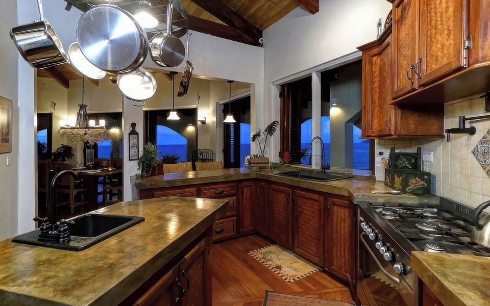 Fully stocked kitchen with stainless steel appliances, gas stove and pot filler.