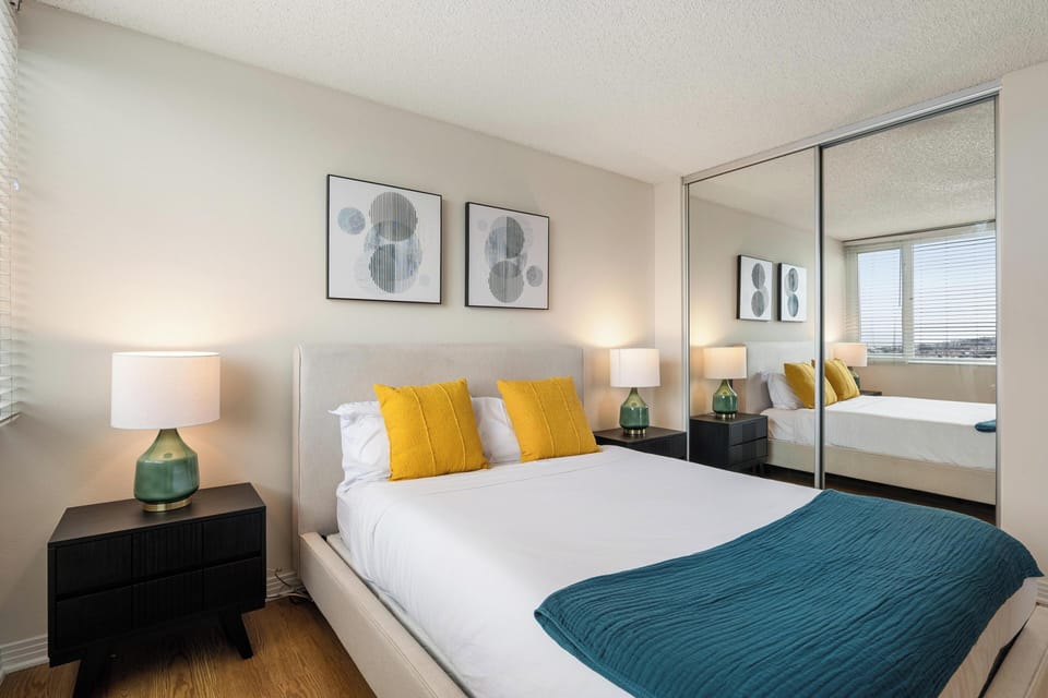 Guest Bedroom with Mirrors -  Chic and sunny room with mirrored closets