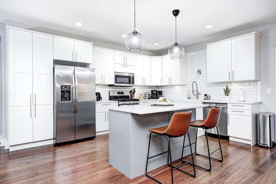 Sleek kitchen with quartz countertops, high-end appliances, and beautiful pendant lighting. The modern design and central island provide the perfect balance of form and function.