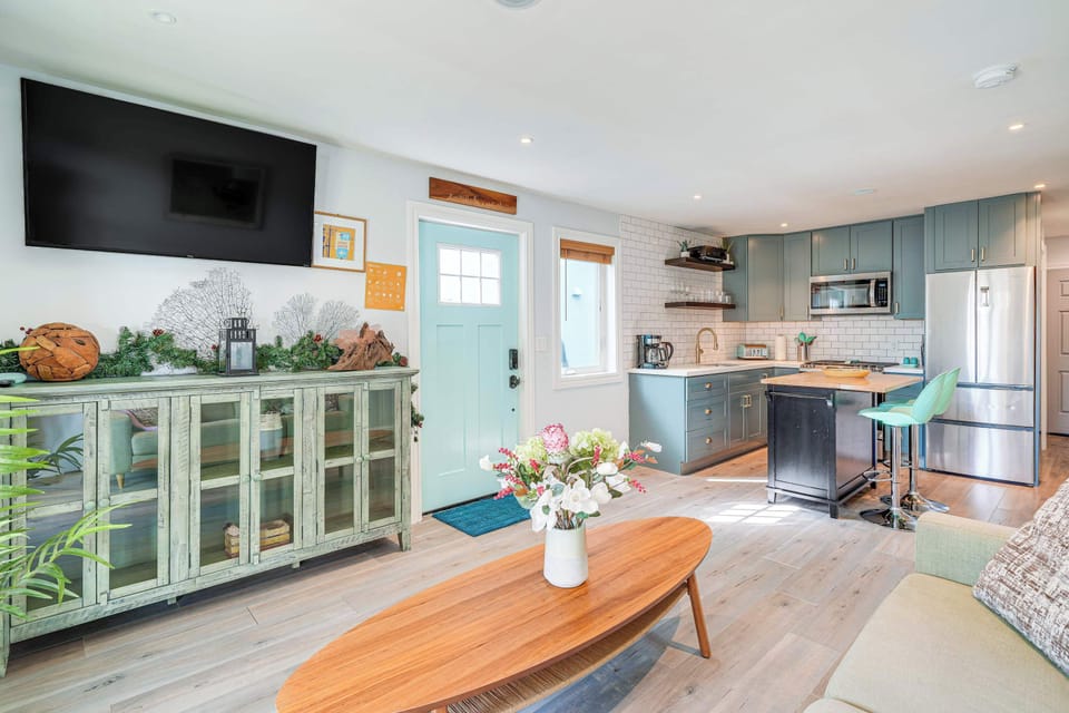 Enjoy the seamless flow of this open-concept living and kitchen area, where cozy seating, charming décor, and a bright modern kitchen come together for a comfortable and welcoming stay