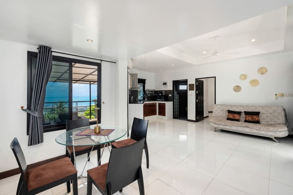 Serene bedroom with stunning ocean and garden views at Moonview Paradise Village Koh Samui