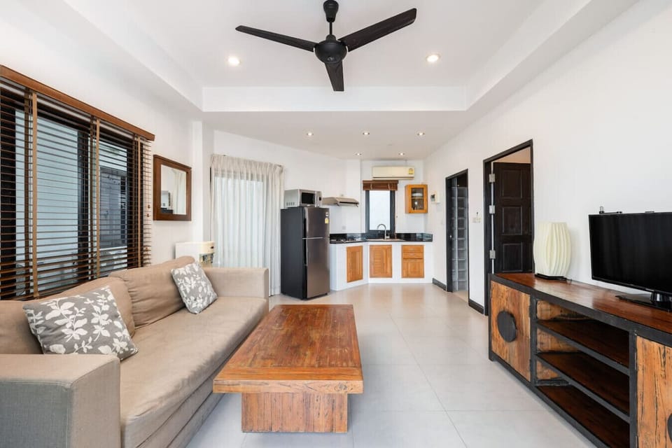 Bright bedroom with wooden shuttered doors and panoramic sea views at Sunview Paradise Village