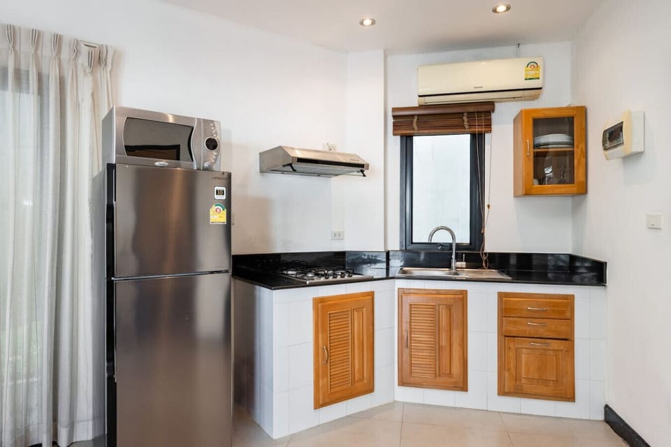 Fully equipped modern kitchen with ample storage at Sunview Paradise Village Koh Samui