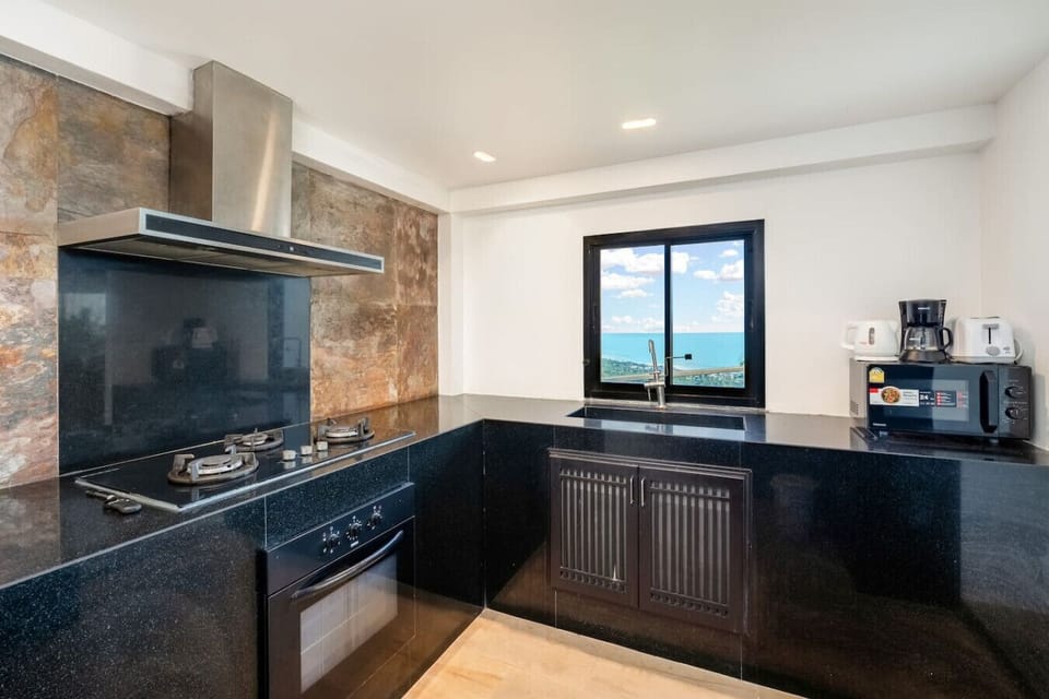 Designer bathroom with dual vanity and dark marble at Sunhouse - Samui hillside villa Paradise Village