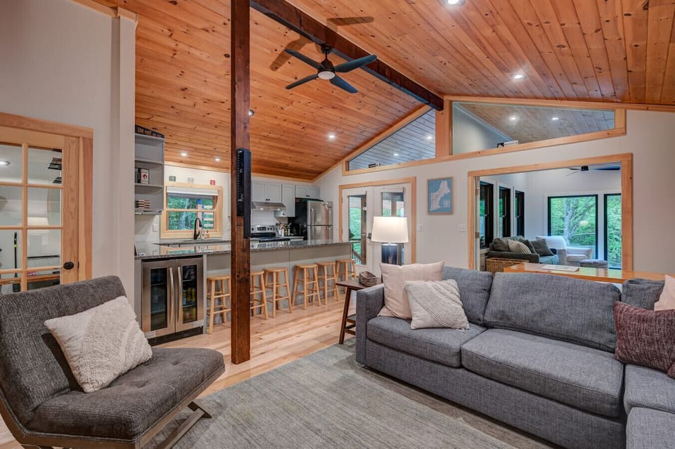 Spacious den with a large TV, comfy seating, board games, and ring toss—perfect for family fun.