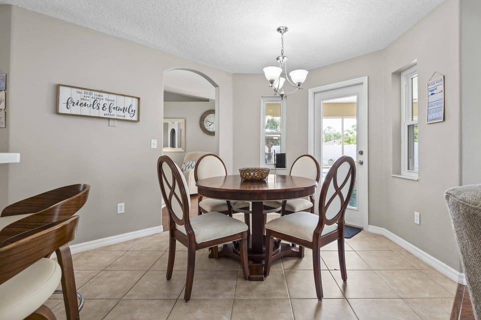 Second dining area overlooking the outdoor space, living room, and kitchen—ideal for shared meals and entertaining.