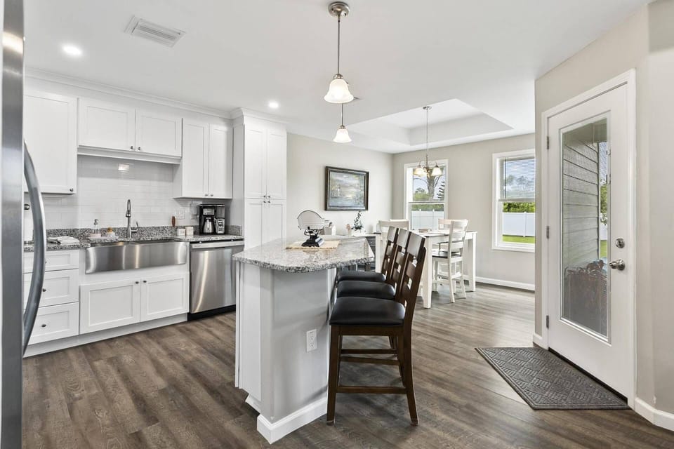 Fully equipped kitchen with modern appliances, ample counter space, and convenient seating—perfect for preparing meals and relaxing during your stay.