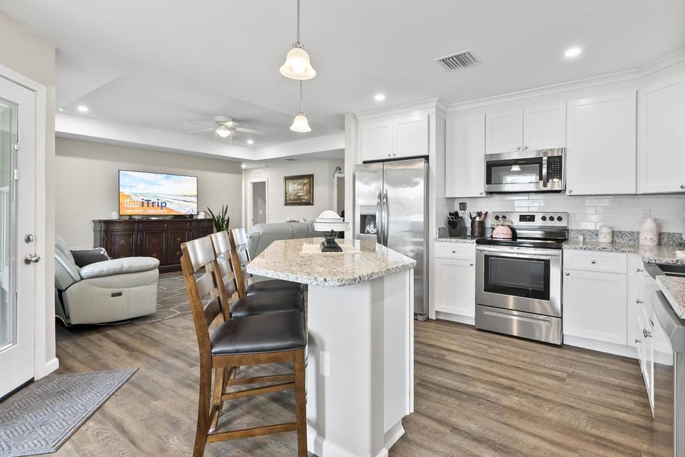 Kitchen area with essential appliances, ample counter space, and seating at the counter for casual dining or socializing.