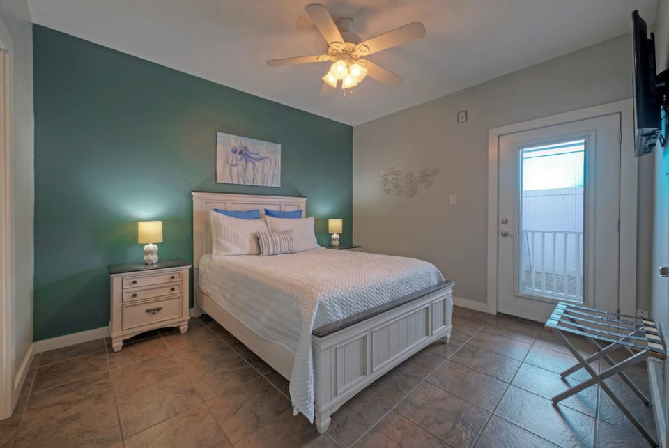 Bedroom 2 features a queen bed, TV and an ensuite bathroom. (Unit 108)